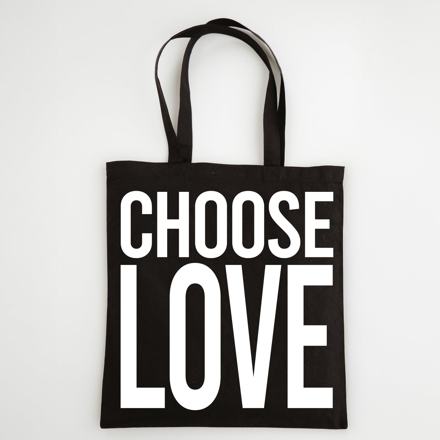 Black tote bag with 'CHOOSE LOVE' text on a white background