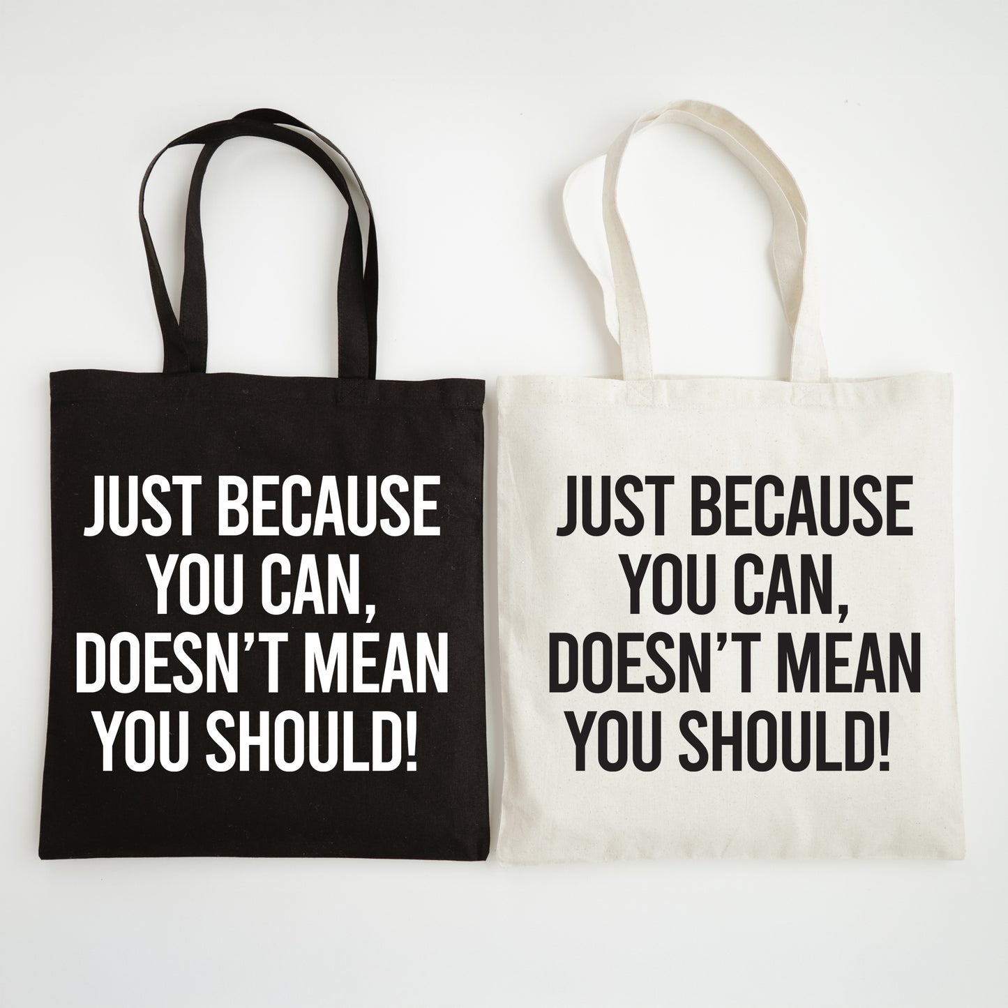 Two tote bags with motivational text on a white background