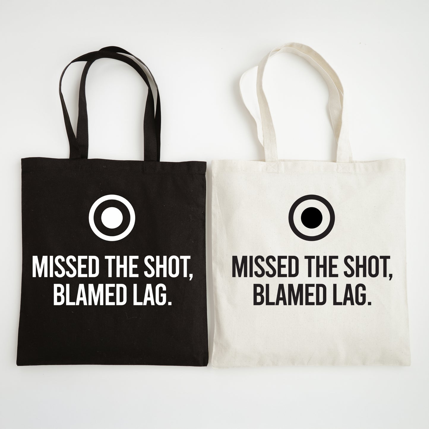 Black and white tote bags with text 'Missed the shot, blamed lag.' on a white background