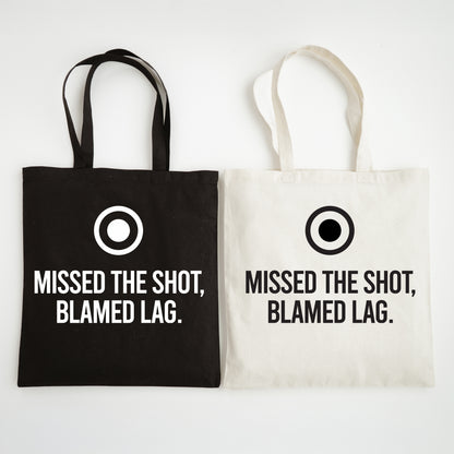 Black and white tote bags with text 'Missed the shot, blamed lag.' on a white background