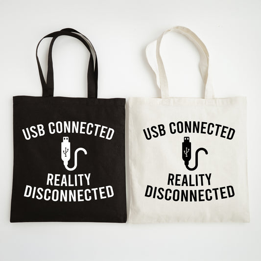 Black and white tote bags with 'USB Connected Reality Disconnected' text and graphics.