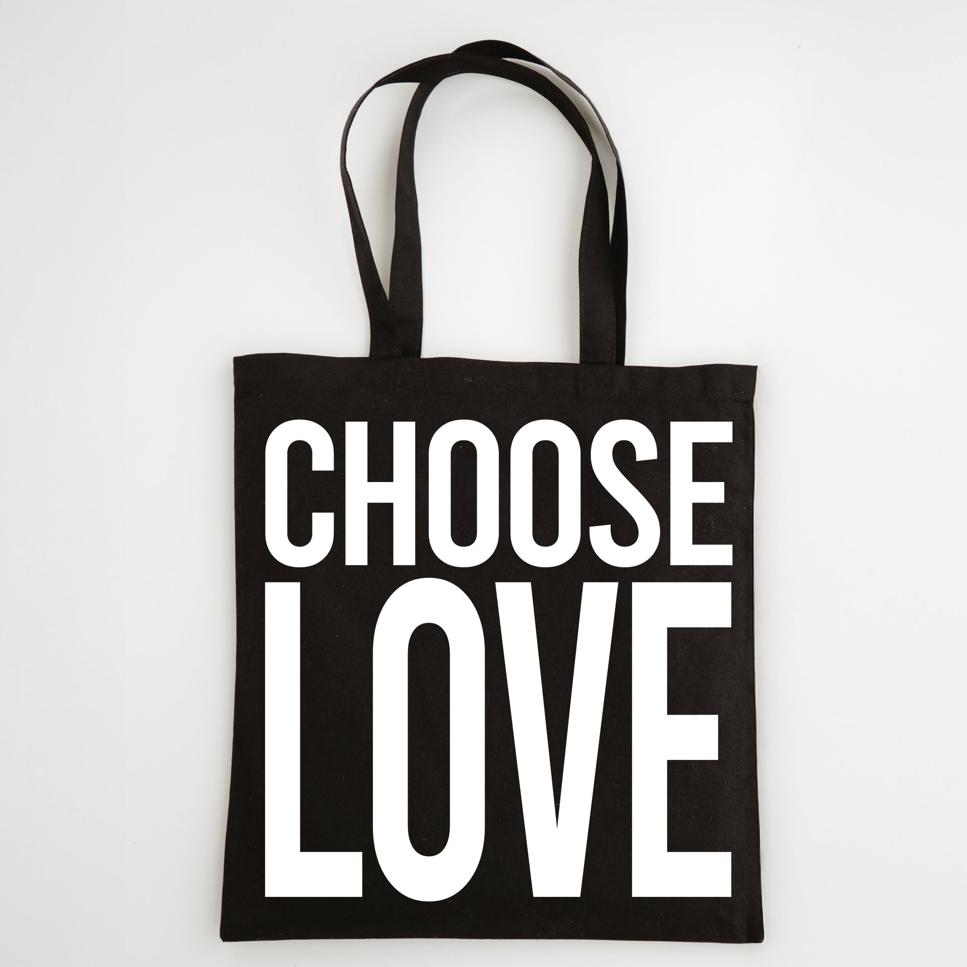 Black tote bag with 'CHOOSE LOVE' text on a white background