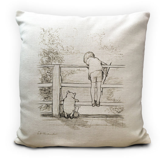 Pillow with a black and white illustration of a child and a bear on a wooden fence.