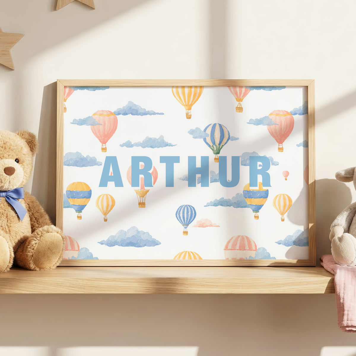 Personalised hot air balloon nursery wall art with child's name and colourful watercolour balloons and clouds