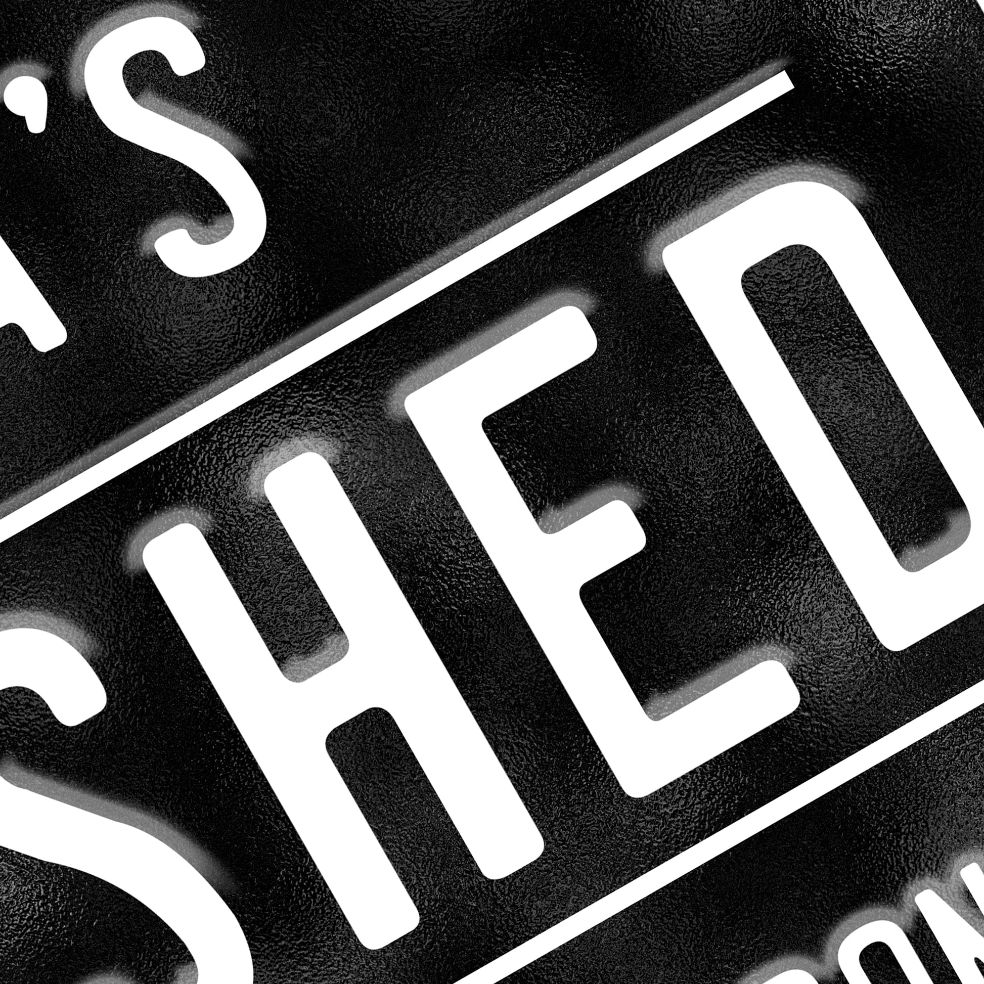 Personalised She Shed Metal Sign in black with white text Close up view 1