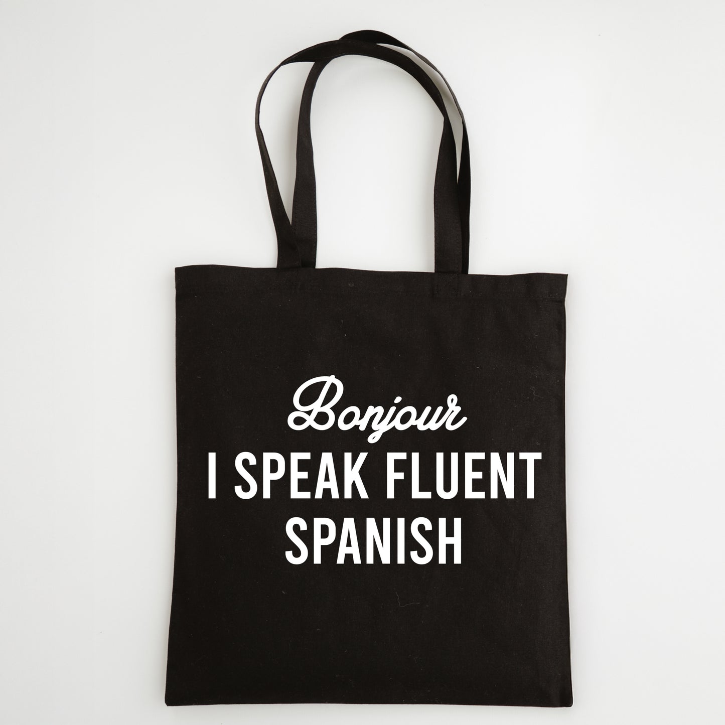 Funny Slogan Tote Bag – “Bonjour, I Speak Fluent Spanish”