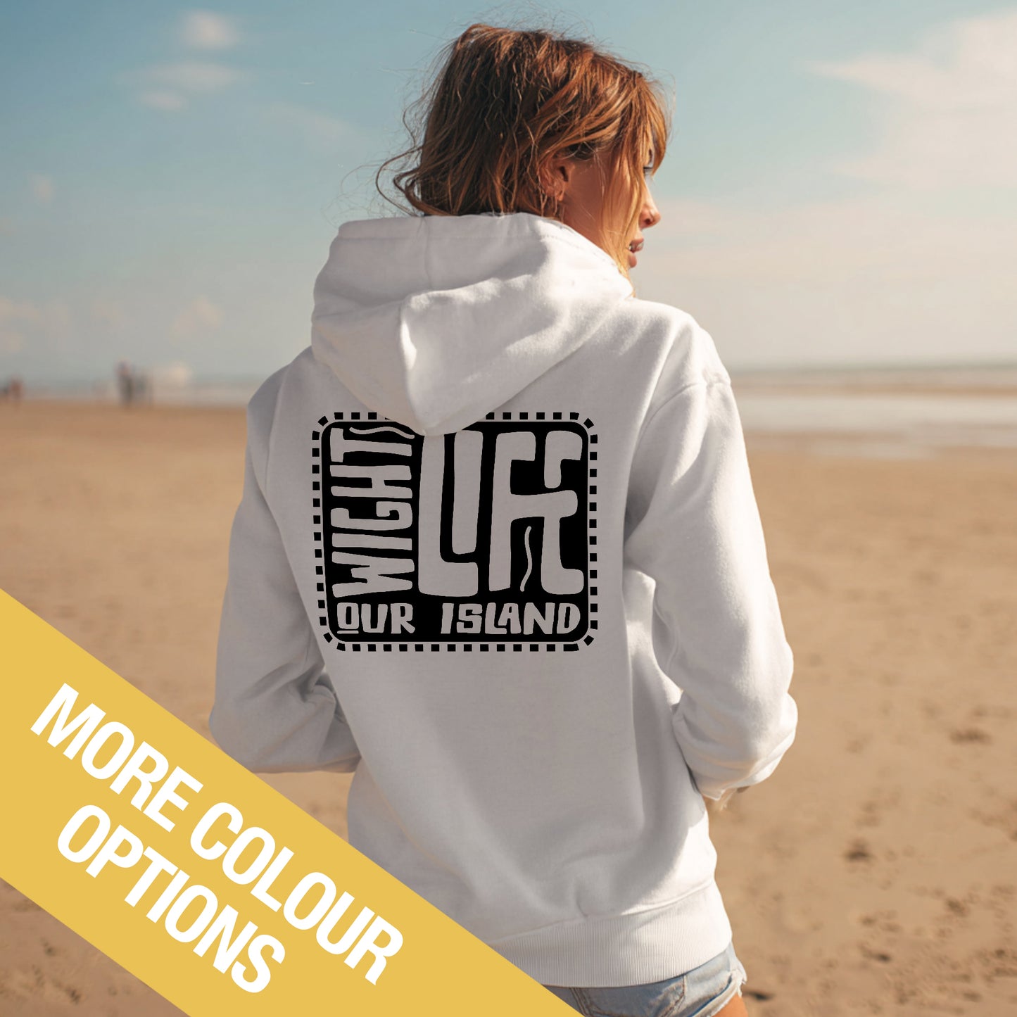 Person wearing a white hoodie with text on the beach, with a yellow banner at the bottom.