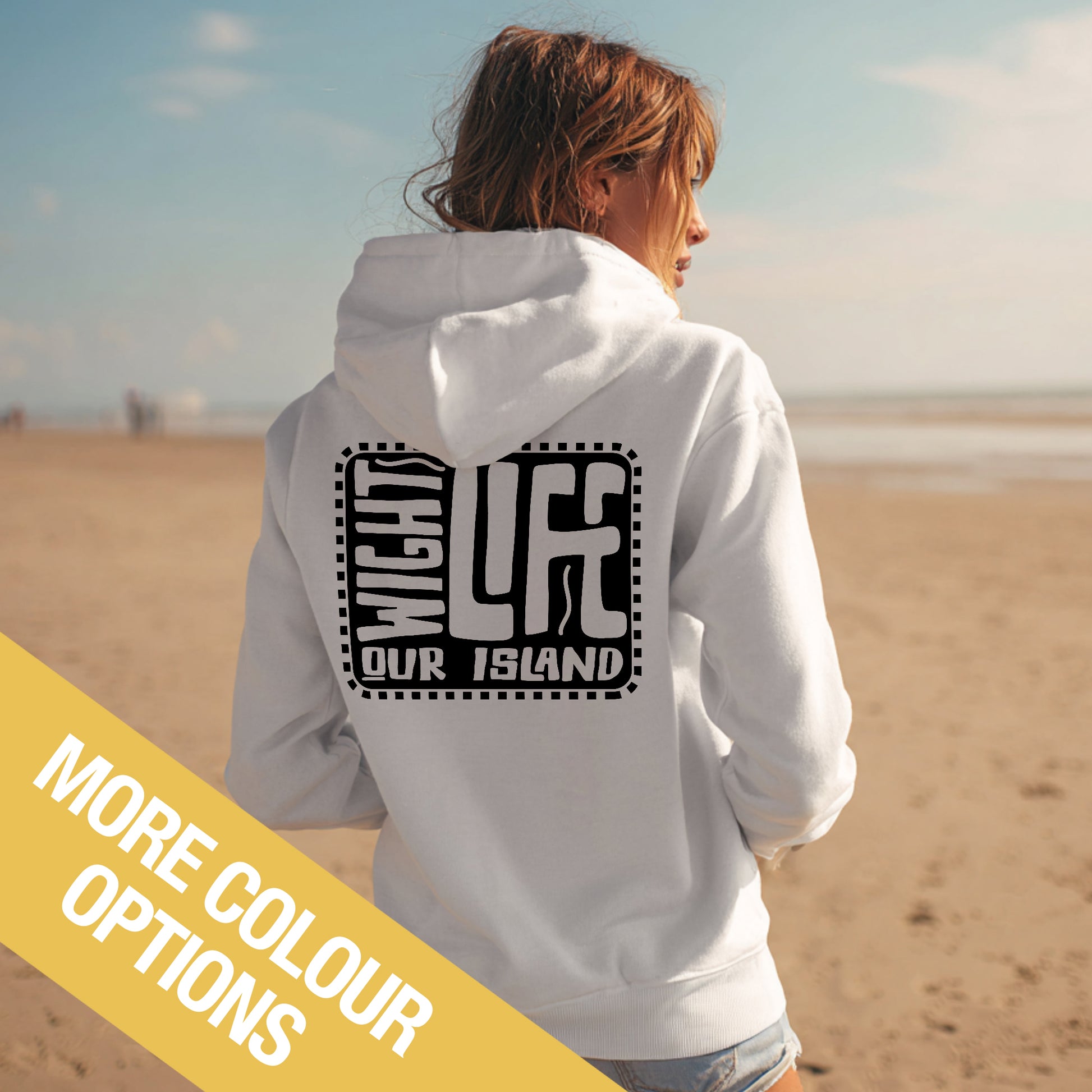 Person wearing a white hoodie with text on the beach, with a yellow banner at the bottom.