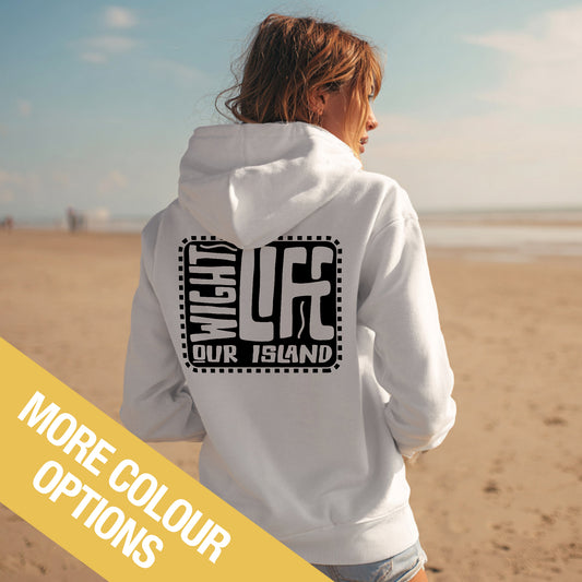 Person wearing a white hoodie with text on the beach, with a yellow banner at the bottom.