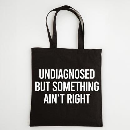 Funny Slogan Tote Bag – “Undiagnosed but Something Ain't Right”