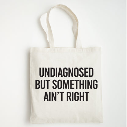 Funny Slogan Tote Bag – “Undiagnosed but Something Ain't Right”