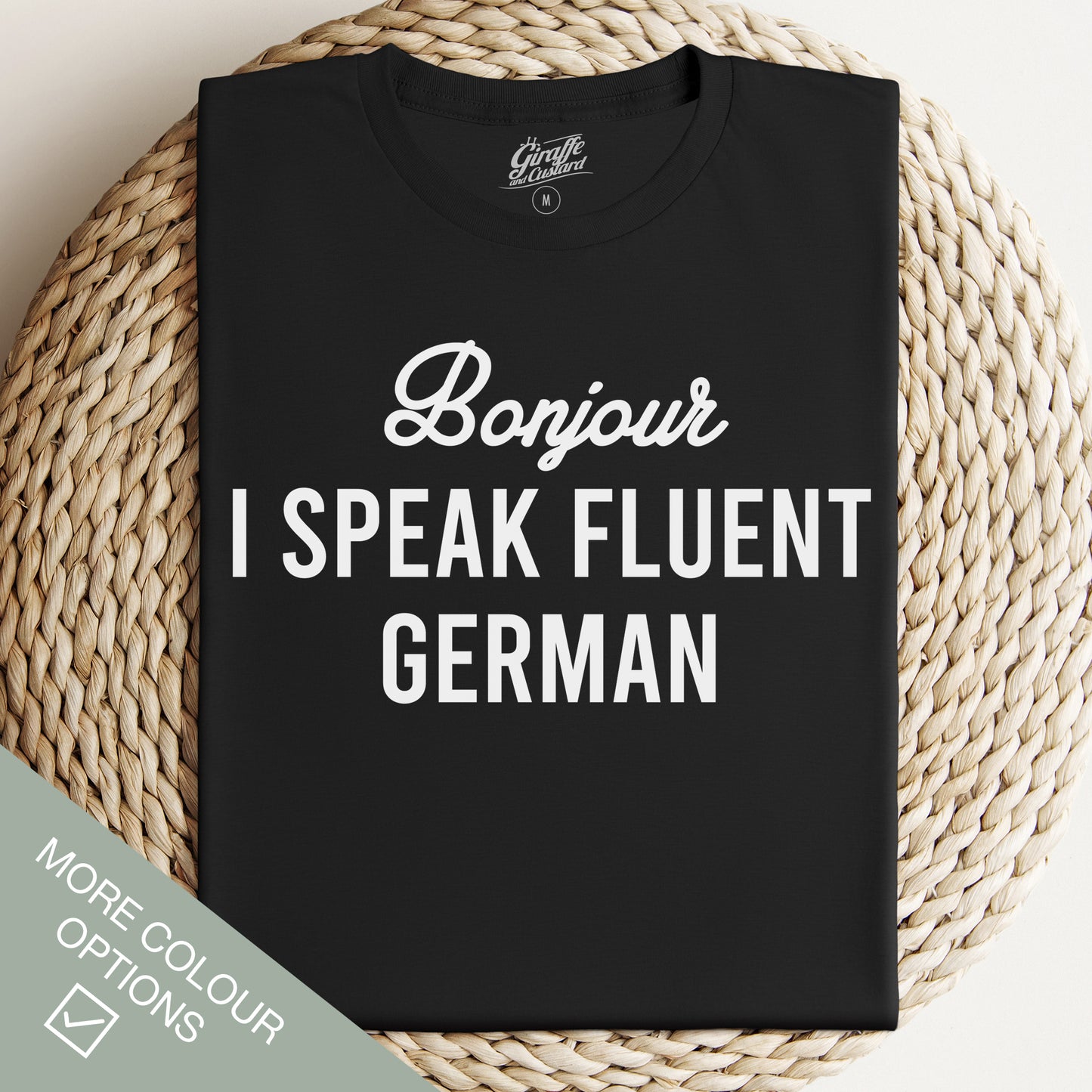 Black crew neck t-shirt with the text 'Bonjour I SPEAK FLUENT GERMAN' printed in white.