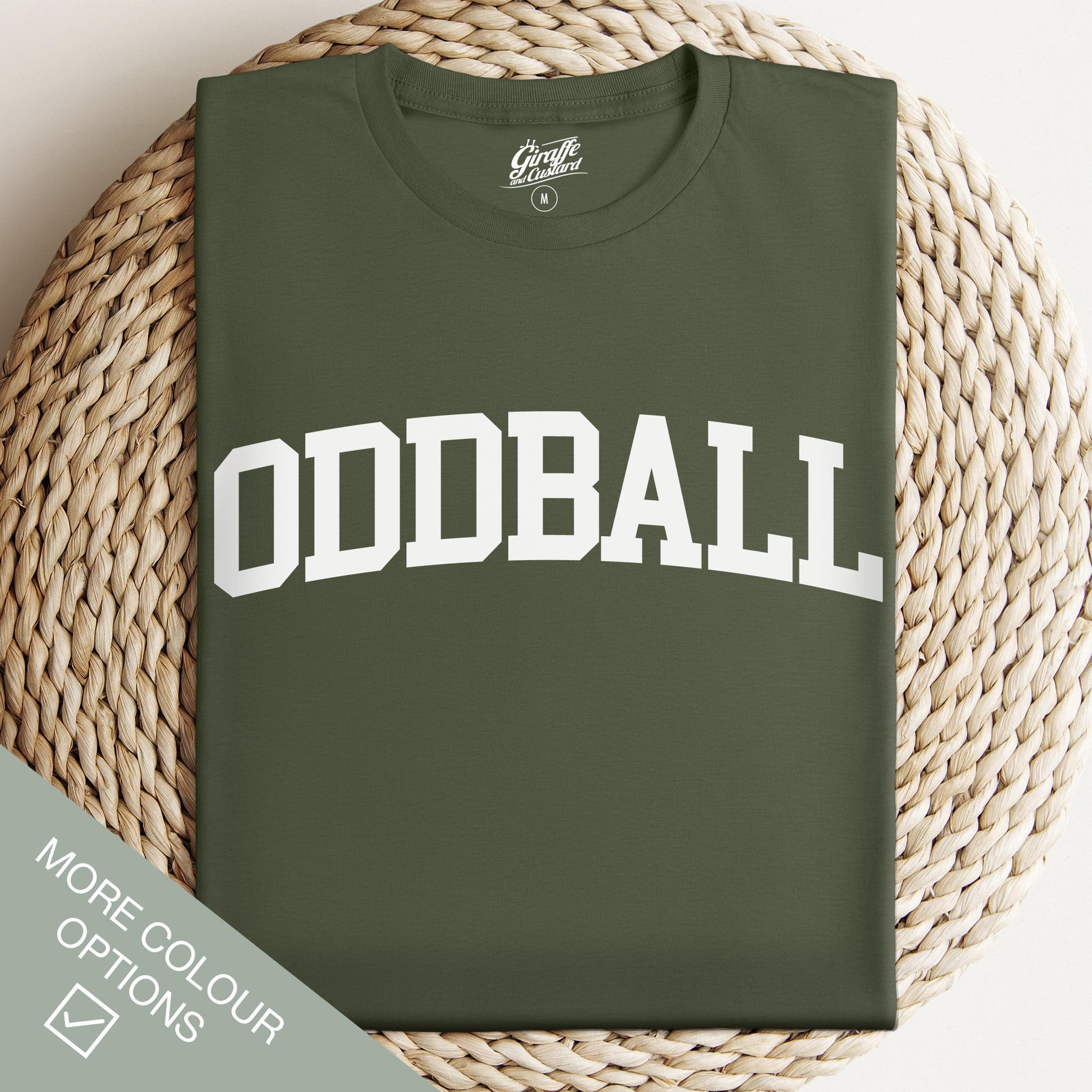 Green t-shirt with 'ODDBALL' text on a woven surface