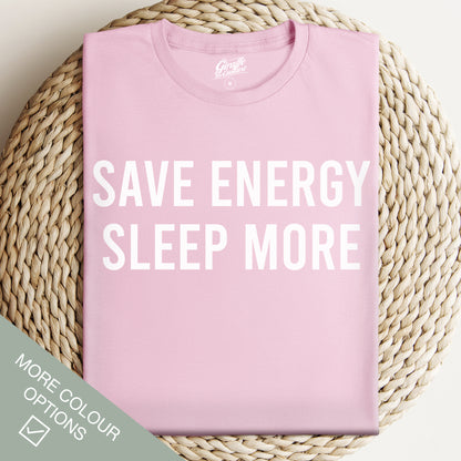 Pink t-shirt with 'SAVE ENERGY SLEEP MORE' text on a woven surface