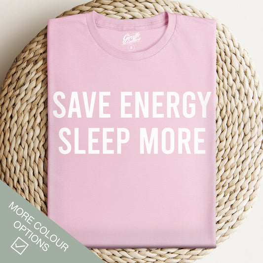 Pink t-shirt with 'SAVE ENERGY SLEEP MORE' text on a woven surface