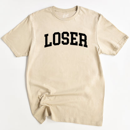 Beige t-shirt with 'LOSER' printed in black on a white background
