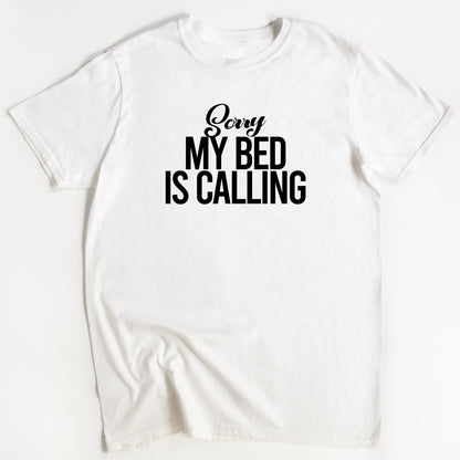 White t-shirt with 'Sorry My Bed Is Calling' text on a white background