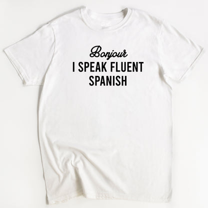 WhiteT-shirt with the text 'Bonjour I SPEAK FLUENT SPANISH' printed in black. Flat Image